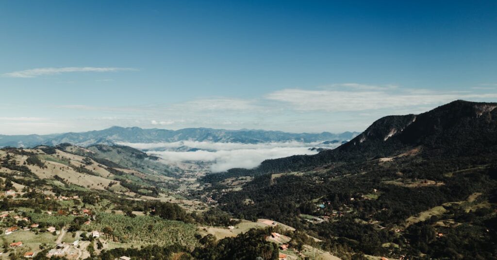 Beautiful aerial view of a mountainous valley beneath a clear blue sky, capturing the essence of nature's beauty.